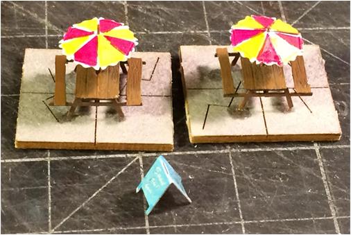 Picnic Tables & Umbrellas with Dishes, Books & Signboard